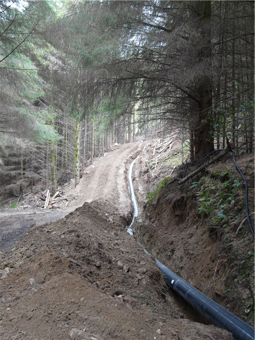 Pipeline reaches the forest track where it will be buried in the uphill bank 15 July 2015 Pipeline reaches the forest track where it will be buried in the uphill bank 15 July 2015