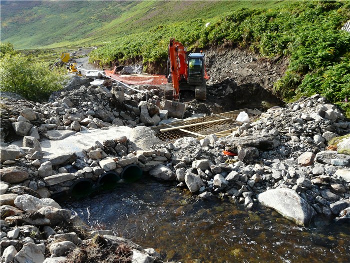 With the river diverted reinforcement for the weir foundation is in place 1 Aug 2015