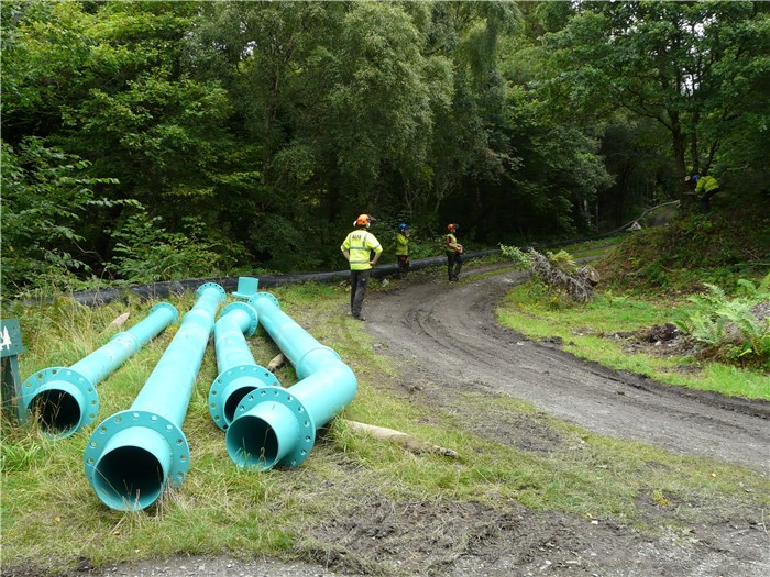 Steel pipe ready for installation down the slope to the turbine house and Alfa Tree Services carrying out some final clearance 24 Aug 2015 Steel pipe ready for installation down the slope to the turbine house and Alfa Tree Services carrying out some final clearance 24 Aug 2015