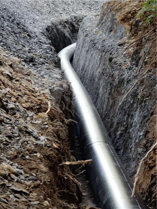 The lowest string of polyethylene pipe in its trench through rock 8 Sept 2015 The lowest string of polyethylene pipe in its trench through rock 8 Sept 2015